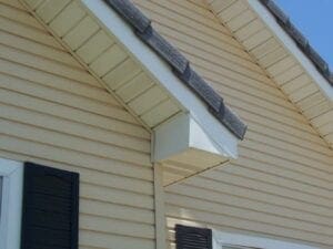 Close-up view of a house's roof overhang and siding.